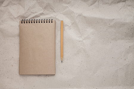brown notebook beside pencil thumbnail