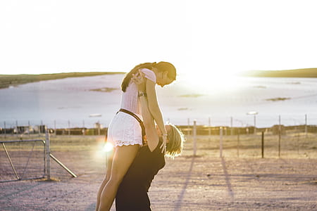 man carrying woman in pink top thumbnail