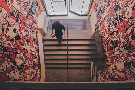 man walking on gray concrete stair near doddle wall thumbnail