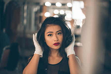 tilt shift lens photography of woman holding his hair thumbnail