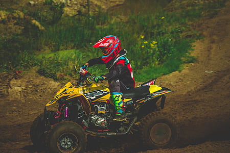 person riding on yellow ATV thumbnail