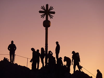silhouette of people on hill beside giant cross thumbnail