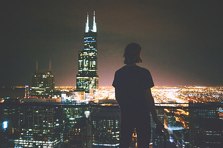 A man enjoying the view across the city at night thumbnail