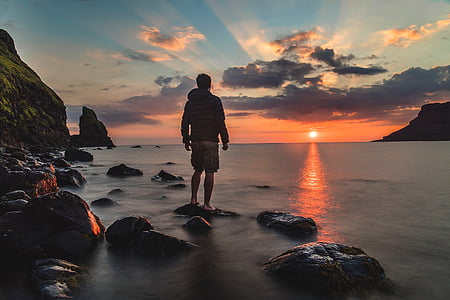 man standing near body of water thumbnail