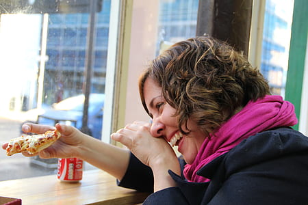 woman smiling while looking at pizza sliced thumbnail