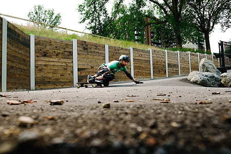 low angle photography of man playing long board thumbnail