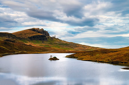 body of water surrounded with mountain thumbnail