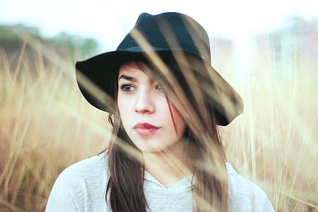 selective focus portrait photography of woman surrounded by grass thumbnail