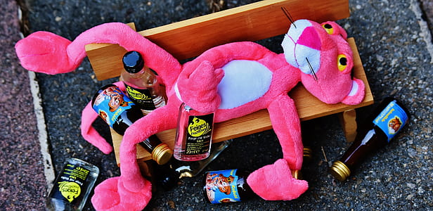 pink panther plush toy lying on bench thumbnail