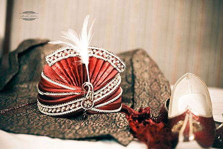 selective focus photography of red and white turban and red jutti thumbnail