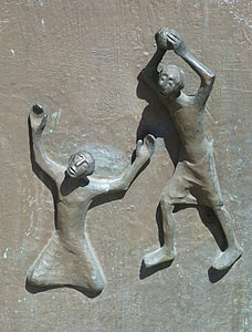 man kneeling beside man raising stone bass relief thumbnail