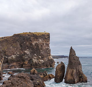 brown mountain cliff on sea thumbnail