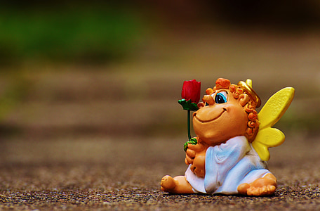 gnow figurine holding red rose thumbnail