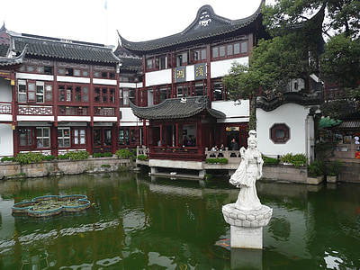 white concrete statue on a green body of water thumbnail