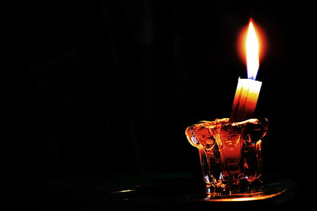 lighted candle on glass candle holder thumbnail