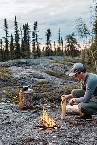 man doing bonfire near top of mountain during daytime thumbnail