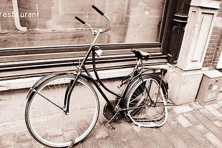 step-through frame bike with broken wheel parked on side on pavement thumbnail