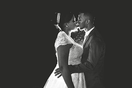 profile of man and woman in wedding suit kissing each other photography thumbnail
