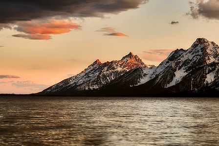 photo of black mountain covered with snow during sunset thumbnail