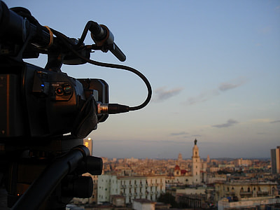 black shoulder mount camera close-up photo with white city on the horizon thumbnail
