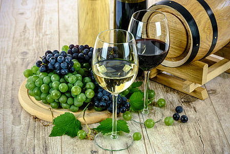 two wine glass beside grapes thumbnail