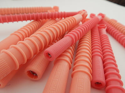 pink plastic tool lot on white textile thumbnail