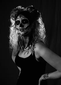 grayscale photography of woman with skull paint face thumbnail
