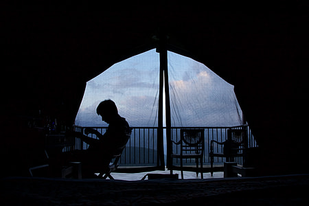 silhouette of man sitting on chair at daytime thumbnail