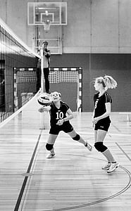 grayscale photo of two woman playing volleyball thumbnail