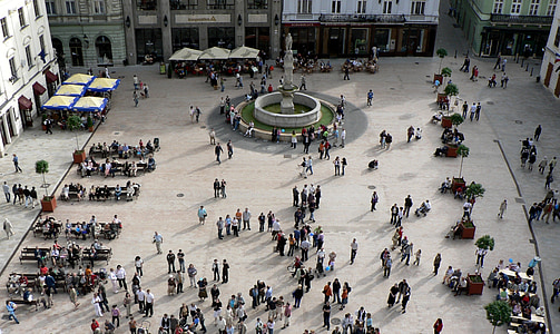 people walking between buildings during daytime thumbnail