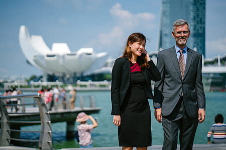 Woman Smiling at Man While Standing Near Marina Bay Sands, Singapore thumbnail