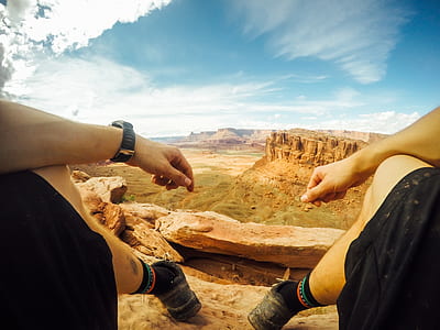 man wearing black shorts and watch sitting on hill thumbnail