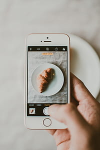 Person Taking Photo of Croissant Bread thumbnail