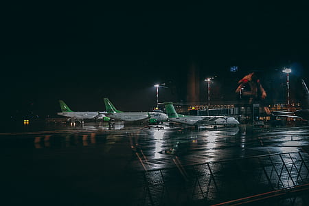 three white airplanes in airport thumbnail