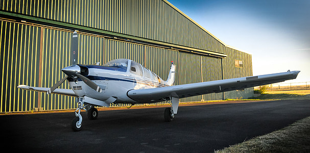 white airplane parked outside the plane garage thumbnail