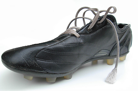 unpaired black soccer cleats on white surface thumbnail