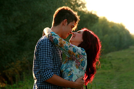 couple embracing each other near trees during daytime thumbnail