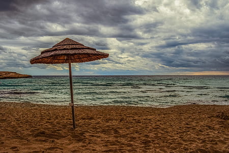brown cottage on seashore thumbnail