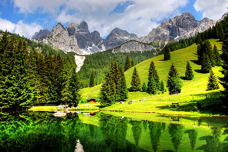 landscape photography body of water near mountain with trees during daytime thumbnail