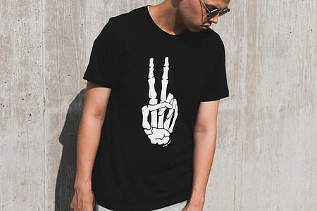 man in black shirt standing in front of the wall thumbnail
