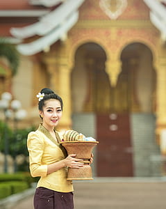 woman holding brown vase thumbnail