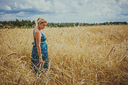 woman standing on grass field wearing blue maxi dress thumbnail