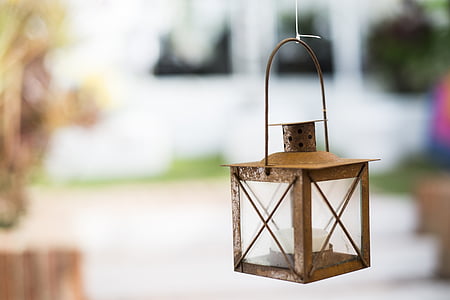 shallow focus photograph of brown candle lantern thumbnail
