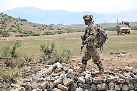soldier holding assault rifle on gray and brown stones thumbnail