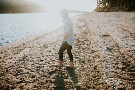 woman on seashore facing body of water thumbnail