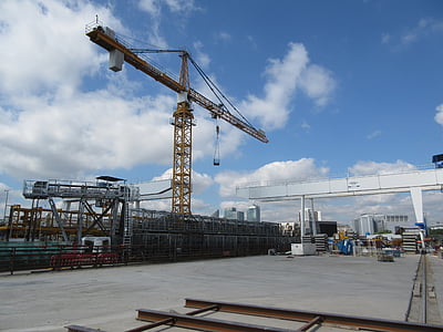 yellow pump jack beside scaffoldings thumbnail