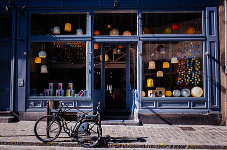 black bicycle in front of black store building thumbnail