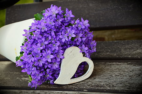 purple cluster flowers in white vase centerpiece closeup photo thumbnail