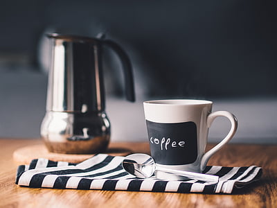 white and black coffee labeled ceramic mu near stainless pitcher thumbnail