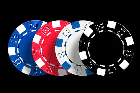 four black, white, red, and blue poker chips thumbnail